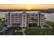 Stunning waterfront condo with beautiful architectural details and lush landscaping at sunset at 8040 Sailboat Key S Blvd # 402, St Pete Beach, FL 33707