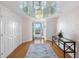 Elegant foyer with chandelier, mirrored ceiling and water view through front door at 8040 Sailboat Key S Blvd # 402, St Pete Beach, FL 33707