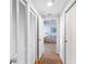 Hallway leading to a living room with wood flooring and a decorative rug, offering a view into the cozy space at 8040 Sailboat Key S Blvd # 402, St Pete Beach, FL 33707