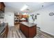 Well-equipped kitchen featuring wooden cabinetry, island, modern appliances, and ample countertop space at 8040 Sailboat Key S Blvd # 402, St Pete Beach, FL 33707