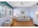 Comfortable living room featuring hardwood floors, a ceiling fan, and plenty of natural light from the large window at 8040 Sailboat Key S Blvd # 402, St Pete Beach, FL 33707