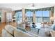 Bright living room featuring water views, comfortable seating, and hardwood floors at 8040 Sailboat Key S Blvd # 402, St Pete Beach, FL 33707