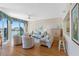 Cozy living room with elegant furnishings, hardwood floors, and stunning water views through large windows at 8040 Sailboat Key S Blvd # 402, St Pete Beach, FL 33707