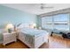 Serene main bedroom with water view, ceiling fan, and light wood floors at 8040 Sailboat Key S Blvd # 402, St Pete Beach, FL 33707