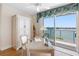 Bright home office with a desk, ample storage, and large windows offering scenic waterfront views at 8040 Sailboat Key S Blvd # 402, St Pete Beach, FL 33707