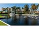 Harbour Side community entrance with a beautiful pond and fountain, framed by lush landscaping and palms at 8040 Sailboat Key S Blvd # 402, St Pete Beach, FL 33707