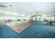 Expansive recreation room with a wooden dance floor, tables, and large windows for natural light at 8040 Sailboat Key S Blvd # 402, St Pete Beach, FL 33707