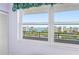 Beautiful water view from condo window with lush landscaping and other buildings in the background at 8040 Sailboat Key S Blvd # 402, St Pete Beach, FL 33707