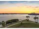 Scenic sunset water view from property showing beach access and park like grounds at 8040 Sailboat Key S Blvd # 402, St Pete Beach, FL 33707