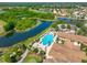 Aerial view of a resort style pool in a community featuring a large lake and beautiful golf course views at 807 Chipper Dr, Sun City Center, FL 33573