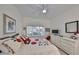 Bright bedroom featuring neutral carpet, a ceiling fan and two windows at 807 Chipper Dr, Sun City Center, FL 33573