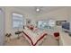 Bright bedroom featuring two windows, ceiling fan, neutral carpet and a television at 807 Chipper Dr, Sun City Center, FL 33573