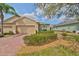 Charming home with a brick driveway, well-manicured landscaping, and a two-car garage at 807 Chipper Dr, Sun City Center, FL 33573