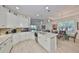 Bright kitchen features white cabinets, granite countertops and stainless steel appliances at 807 Chipper Dr, Sun City Center, FL 33573