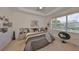 This modern main bedroom offers plush carpet, tray ceiling and a sitting area by the window at 807 Chipper Dr, Sun City Center, FL 33573