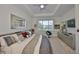 Bright main bedroom featuring plush carpet, large bed and dresser with mounted tv at 807 Chipper Dr, Sun City Center, FL 33573