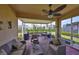 Comfortable screened patio with ceiling fan, lounge seating, dining table and grill for outdoor entertaining at 807 Chipper Dr, Sun City Center, FL 33573