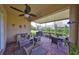 Relaxing screened patio with ceiling fan, comfortable seating, and a grill for outdoor enjoyment at 807 Chipper Dr, Sun City Center, FL 33573