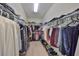 Spacious walk-in closet with ample shelving and hanging space for clothes and shoes at 807 Chipper Dr, Sun City Center, FL 33573