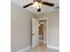 Bedroom boasts tile flooring, a ceiling fan, and doorway at 8311 Millwood Dr, Tampa, FL 33615