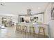 Modern kitchen with an island, barstool seating, and stainless steel appliances overlooking the dining area at 8311 Millwood Dr, Tampa, FL 33615