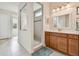 Modern bathroom with a sleek vanity, a walk-in shower with glass accents, and ample lighting at 834 Birdie Way, Apollo Beach, FL 33572