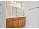 Bright bathroom vanity with modern fixtures, mirror and access to shower area at 834 Birdie Way, Apollo Beach, FL 33572