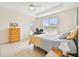 Spacious bedroom with tray ceiling, a ceiling fan, and large window with blinds at 834 Birdie Way, Apollo Beach, FL 33572