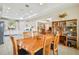 Bright dining area with a wooden table, comfortable seating, and view of the modern kitchen and living space at 834 Birdie Way, Apollo Beach, FL 33572