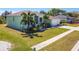 Stylish single-Gathering home boasts a two-car garage, screened porch, lush lawn, and palm trees at 834 Birdie Way, Apollo Beach, FL 33572