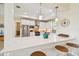 Gorgeous kitchen with white quartz countertops, stainless steel appliances, and tray ceilings at 834 Birdie Way, Apollo Beach, FL 33572