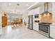 Open-concept kitchen and dining area features stainless steel appliances, tile floors and natural light at 834 Birdie Way, Apollo Beach, FL 33572