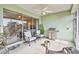Covered lanai with comfortable seating, a grill, and an open view of outdoor space at 834 Birdie Way, Apollo Beach, FL 33572