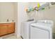 Convenient laundry room with modern washer, dryer, and utility sink at 834 Birdie Way, Apollo Beach, FL 33572