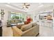 Open-concept living area with a large window, tile floors, and seamless flow to the kitchen and dining space at 834 Birdie Way, Apollo Beach, FL 33572