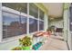 A relaxing screened in patio with comfortable seating and ceiling fan, perfect for enjoying the outdoors at 834 Birdie Way, Apollo Beach, FL 33572