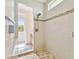 Elegant walk-in shower with mosaic tile accents, a rain shower head, and access to the rest of the bathroom at 834 Birdie Way, Apollo Beach, FL 33572