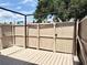 A wood-planked back patio with a framed trellis overlooks a tree-lined vista at 8711 Plum Ln, Temple Terrace, FL 33637