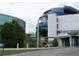 This building has a modern design with a combination of curved glass and concrete elements at 8711 Plum Ln, Temple Terrace, FL 33637