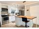 Modern kitchen features white cabinets, stainless appliances, and a butcher block island at 8711 Plum Ln, Temple Terrace, FL 33637