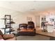 View of living room with recliners, shelves and kitchen bar seating in background at 8711 Plum Ln, Temple Terrace, FL 33637