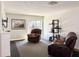 Comfortable living room with recliners, sliding glass door to patio, and decorative fireplace at 8711 Plum Ln, Temple Terrace, FL 33637