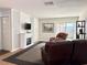 Inviting living room featuring a fireplace, built-in shelving, and sliding doors to the outdoors at 8711 Plum Ln, Temple Terrace, FL 33637