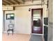 This is a screened-in patio featuring tile flooring, wooden support beams, and seating at 8711 Plum Ln, Temple Terrace, FL 33637