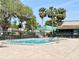 Community swimming pool with brick paver surround and lounge chairs at 8711 Plum Ln, Temple Terrace, FL 33637