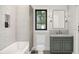 Bathroom with white subway tile, framed mirror, and dark vanity at 10086 Hilltop Dr, New Port Richey, FL 34654
