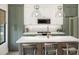 Modern kitchen featuring an island, white and green cabinetry, and stainless steel appliances at 10086 Hilltop Dr, New Port Richey, FL 34654