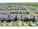 Expansive aerial view of a residential neighborhood with lush greenery and a serene lake at 10205 Cool Waterlily Ave, Riverview, FL 33578
