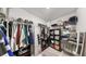 Well-organized walk-in closet with shelving and hanging racks for optimal storage and organization at 10205 Cool Waterlily Ave, Riverview, FL 33578