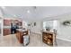 This open kitchen and dining area features dark wood cabinets and lots of light at 10205 Cool Waterlily Ave, Riverview, FL 33578